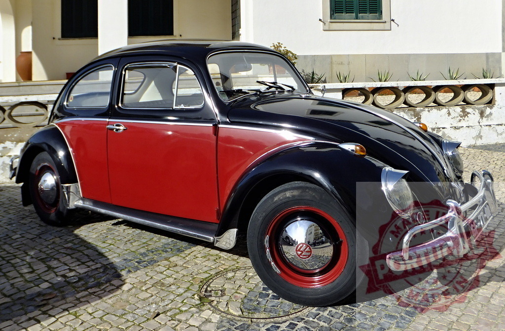Classic Volkswagen Beetle parked in front of a white building | Shiny vintage Volkswagen Beetle with red and black two-tone paint job parked on a cobblestone street - Realized with Pictrs.com