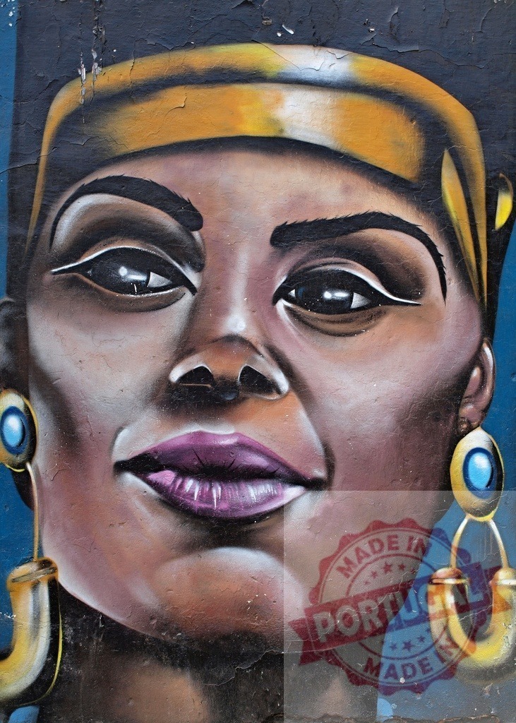 African woman mural street art portrait celebrating empowerment | African woman street art portrait wearing headwrap and earrings, showing cultural beauty - Realized with Pictrs.com