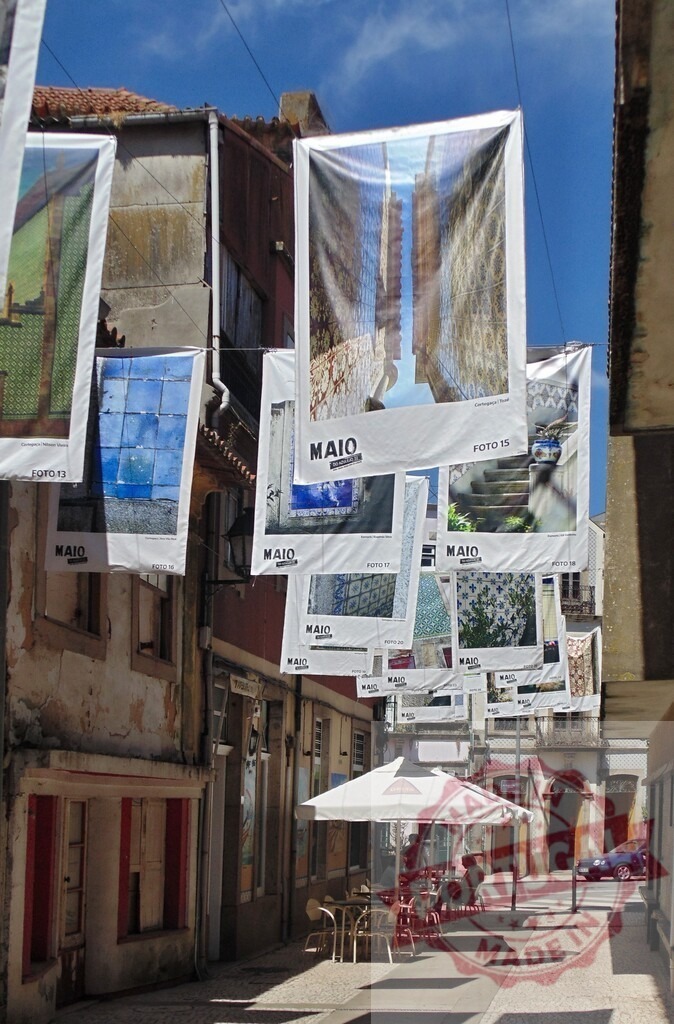 Street decorated with hanging cultural banners for festival. Aveiro - Portugal | Street decorations showing traditional Portuguese tiles and patterns during a local festival - Realized with Pictrs.com