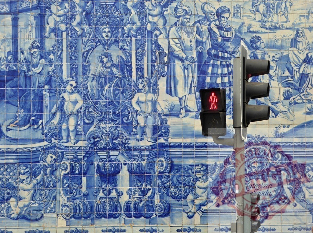 Azulejo tiles Portugal street with pedestrian crossing light | Blue and white Azulejo ceramic tiles depicting historic scenes with a red pedestrian signal - Realized with Pictrs.com
