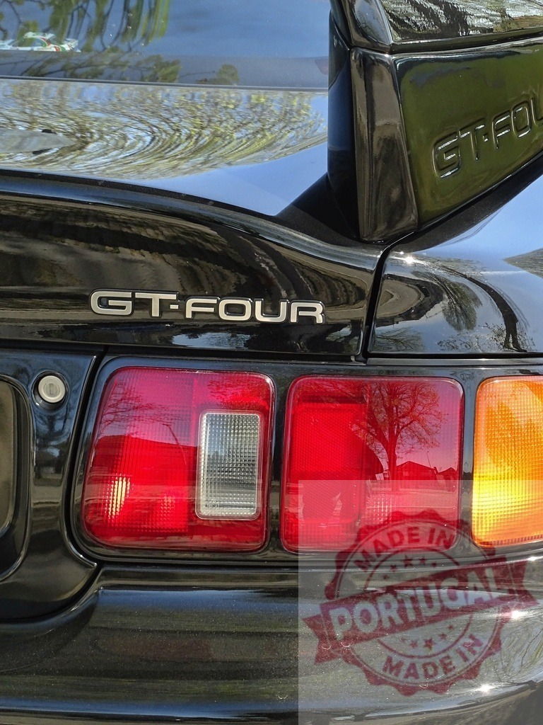 Toyota Celica GT-Four sports car rear detail | Toyota Celica GT-Four black car rear showing taillights and GT-FOUR emblem - Realized with Pictrs.com
