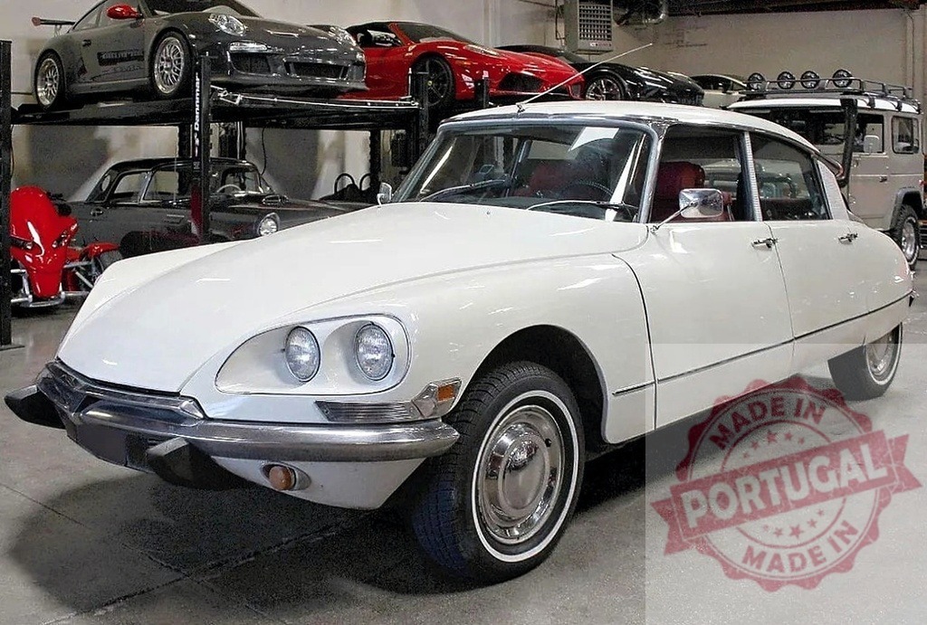 White Citroen DS vintage car in modern garage collection | Classic white Citroen DS parked among other luxury and vintage vehicles in a private collection - Realisiert mit Pictrs.com