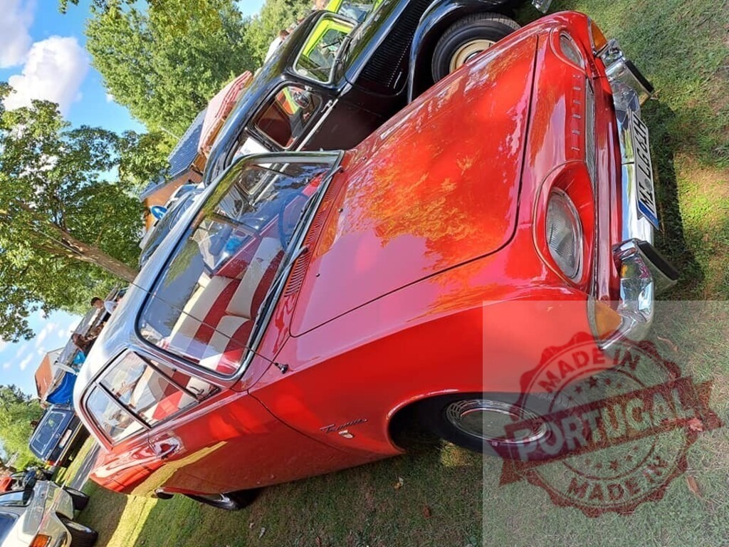 Shiny red Ford Taunus P4 parked on grass during vintage car meeting | Classic Ford Taunus car parked on grass field during sunny summer day at vintage car exhibition - Realized with Pictrs.com