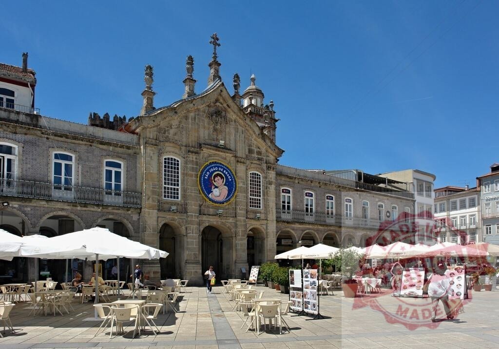 Praça da República in Braga with SÃO JOÃO banner. Norte - Portugal | Praça da República featuring historic architecture, outdoor cafes, and a banner for SÃO JOÃO - Realized with Pictrs.com