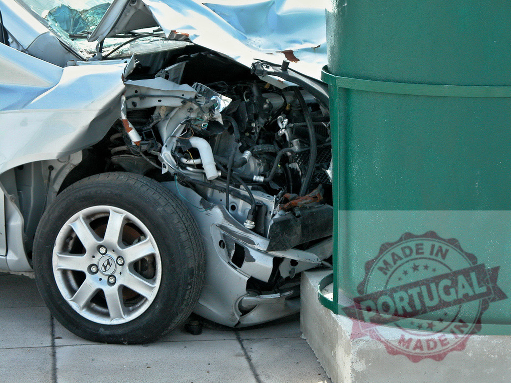 Wrecked car hitting a green dumpster after dangerous road accident | Silver car hitting a green dumpster after dangerous road accident, showing serious damages - Realized with Pictrs.com