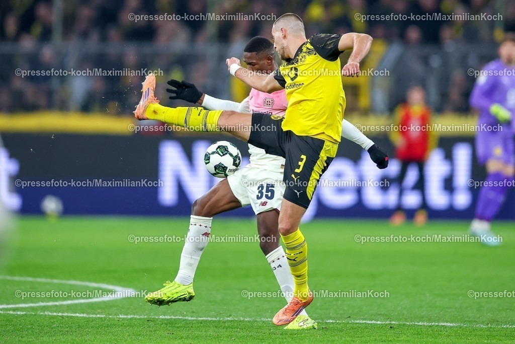 BVB02122501077 | 02.12.2025, Fußball, DFB-Pokal, Borussia Dortmund - Bayer 04 Leverkusen, Achtelfinale, Signal Iduna Park, Saison 2025 2026: Waldemar Anton (BVB #03) im Zweikampf gegen  Christian Kofane (Bayer04 #35) DFB regulations prohibit any use of photographs as image sequences and or quasi-video.