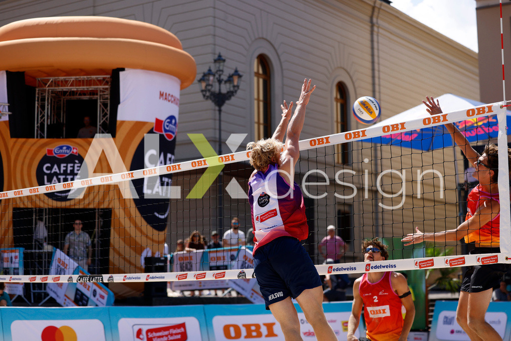 Obi BeachTour 2026 - Basel | BASEL, SWITZERLAND - JULY 18: DANIEL ALLEMANN (SUI) attack / spike against JACOB HEJLSVIG PETERSEN (DEN) block during the Obi BeachTour 2026 match between ALLEMANN / LEFFLER (SUI) and MASSEREY / SCHNEGG (SUI) at Barfüsserplatz on July 18, 2026 in Basel, Switzerland. - Realisiert mit Pictrs.com