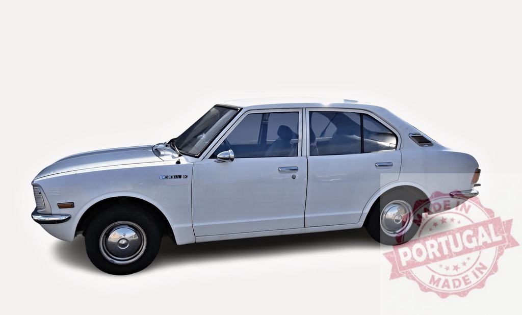 White Toyota Corolla KE20 posing in a studio | Classic white Toyota Corolla KE20 from the 70s parked in a studio with white background - Realized with Pictrs.com