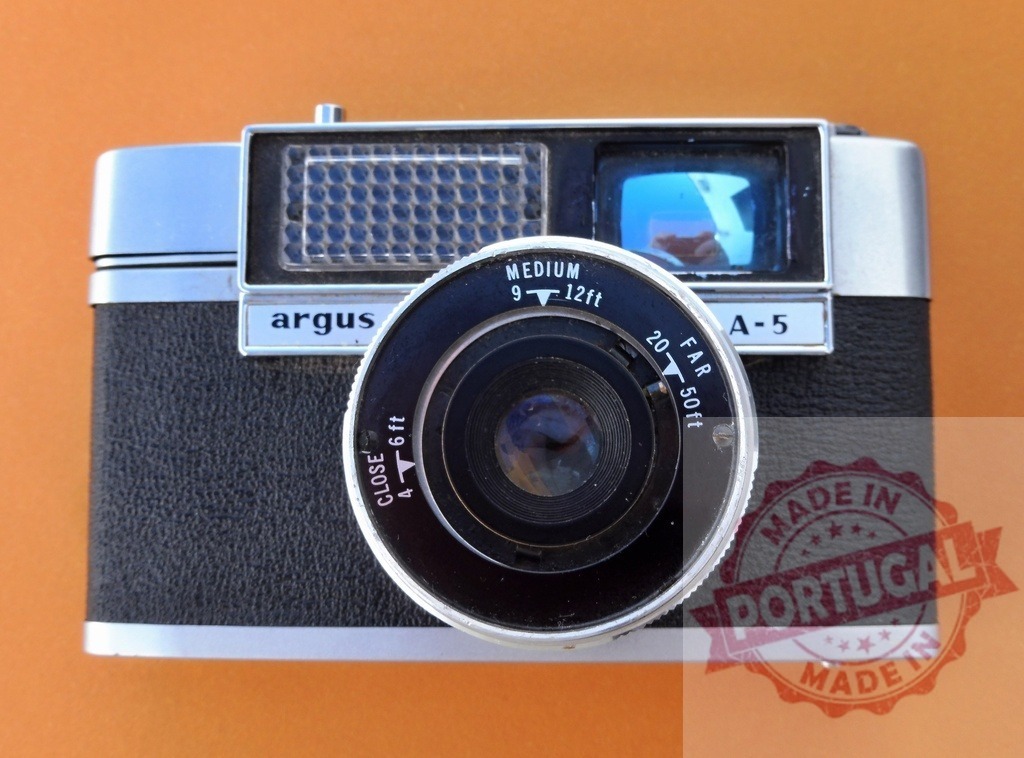 Argus A-5 film camera representing vintage photography technology | Argus A-5 camera providing a classic retro film design against an orange background - Realisiert mit Pictrs.com