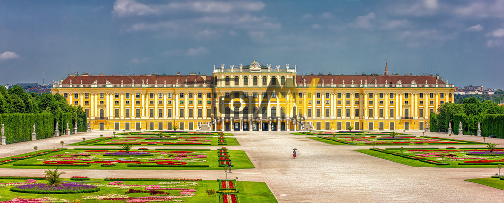 Panorama des Schloss Schönbrunn in Wien----Österreich | Das abgebildete Gebäude ist das Schloss Schönbrunn in Wien, Österreich. Es war die ehemalige Sommerresidenz der Habsburger und zählt zu den bedeutendsten Kulturgütern und meistbesuchten Sehenswürdigkeiten des Landes. Hier sind einige Details über das Schloss:Die barocke Schlossanlage wurde ab 1695 begonnen und im Laufe des 18. Jahrhunderts unter Kaiserin Maria Theresia fertiggestellt. Das Schloss und der weitläufige Schlosspark gehören seit 1996 zum UNESCO-Weltkulturerbe. Es verfügt über 1.441 Zimmer, von denen 45 für Besucher zugänglich sind. Der Schlosspark, der das ganze Jahr über kostenlos zugänglich ist, beherbergt zahlreiche Attraktionen wie den Tiergarten Schönbrunn, einen Irrgarten und die Gloriette.  - Realisiert mit Pictrs.com