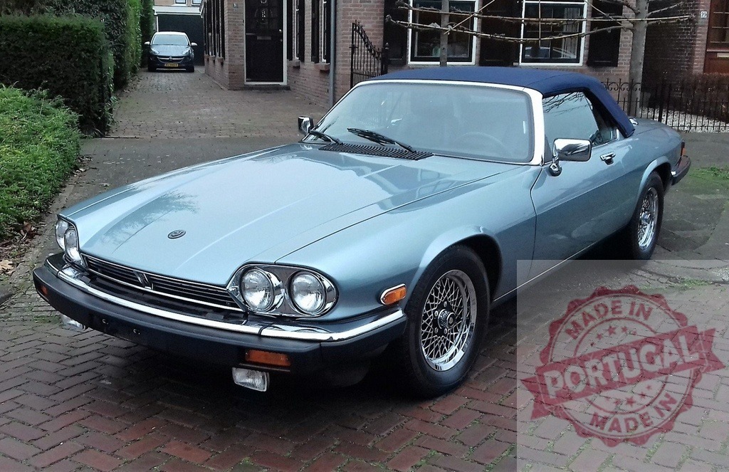 Light blue Jaguar XJ-S parked on a brick driveway | Classic Jaguar XJ-S convertible parked in front of a house, showcasing its elegant design and timeless appeal - Realized with Pictrs.com