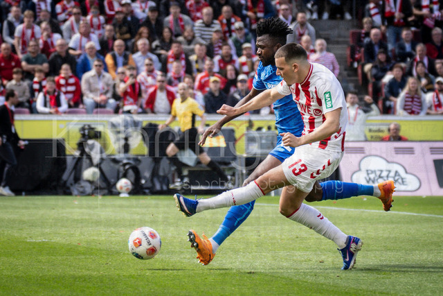 German Bundesliga,  1. FC Koeln - Bayer 04 Leverkusen, 25.04.2026 | KOELN, GERMANY - APRIL 25, 2026 :  Said El Mala  (1. FC Koeln, 13) shoots the ball, Edmond Tapsoba (Bayer 04 Leverkusen, 12) tries to tackle during the German Bundesliga match on gameday 31 between 1. FC Koeln - Bayer 04 Leverkusen at RheinEnergieSTADION on April 25, 2026 in Koeln, Germany. DFL REGULATIONS PROHIBIT ANY USE OF PHOTOGRAPHS AS IMAGE SEQUENCES AND/OR QUASI-VIDEO.