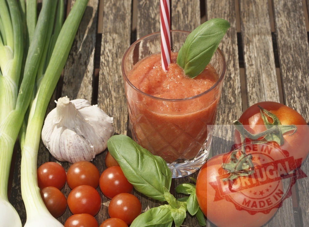 Gazpacho drink with fresh tomatoes and herbs | Gazpacho drink with basil leaf, tomatoes, garlic, and spring onions on a wooden table - Realized with Pictrs.com