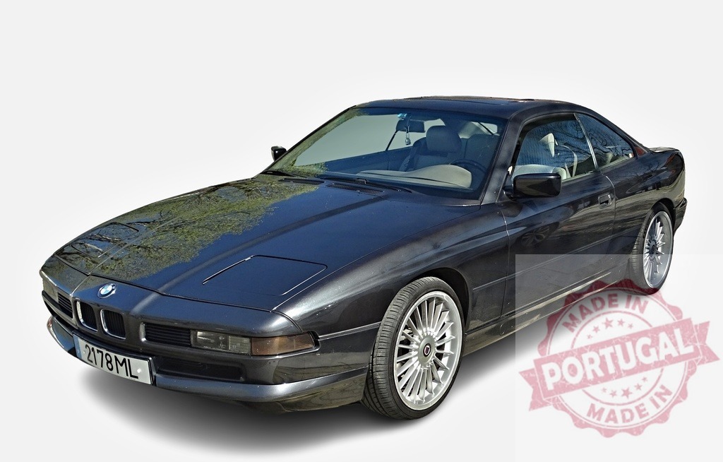 BMW 8 Series parked, reflecting trees on its polished hood | Classic BMW 8 Series coupe reflecting trees on its polished hood, showing its elegant design and luxury - Realized with Pictrs.com