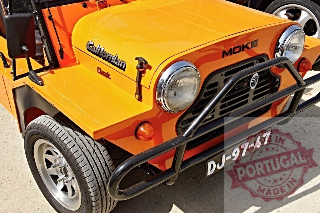 Orange Moke Californian classic vintage car details | Moke Californian classic car showing front details, grill, bumper, and headlights in orange - Realized with Pictrs.com