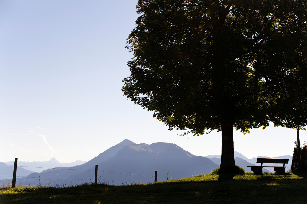 Bergkulisse mit Bank | Dornbirn, Austria - September 21, 2010: Bergkulisse mit Bank. - Realisiert mit Pictrs.com