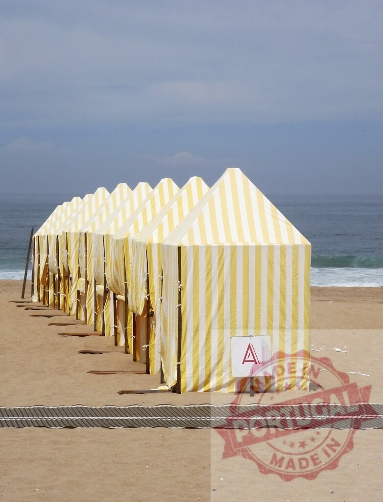 Aveiro Region - Portugal Row of yellow striped beach tents on sand | Row of yellow striped tents standing on sand near the ocean on a summer day - Realisiert mit Pictrs.com