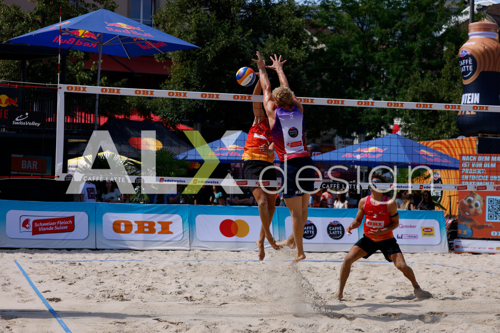 Obi BeachTour 2026 - Basel | BASEL, SWITZERLAND - JULY 18: DANIEL ALLEMANN (SUI) attack / spike against JACOB HEJLSVIG PETERSEN (DEN) block during the Obi BeachTour 2026 match between ALLEMANN / LEFFLER (SUI) and MASSEREY / SCHNEGG (SUI) at Barfüsserplatz on July 18, 2026 in Basel, Switzerland. - Realisiert mit Pictrs.com