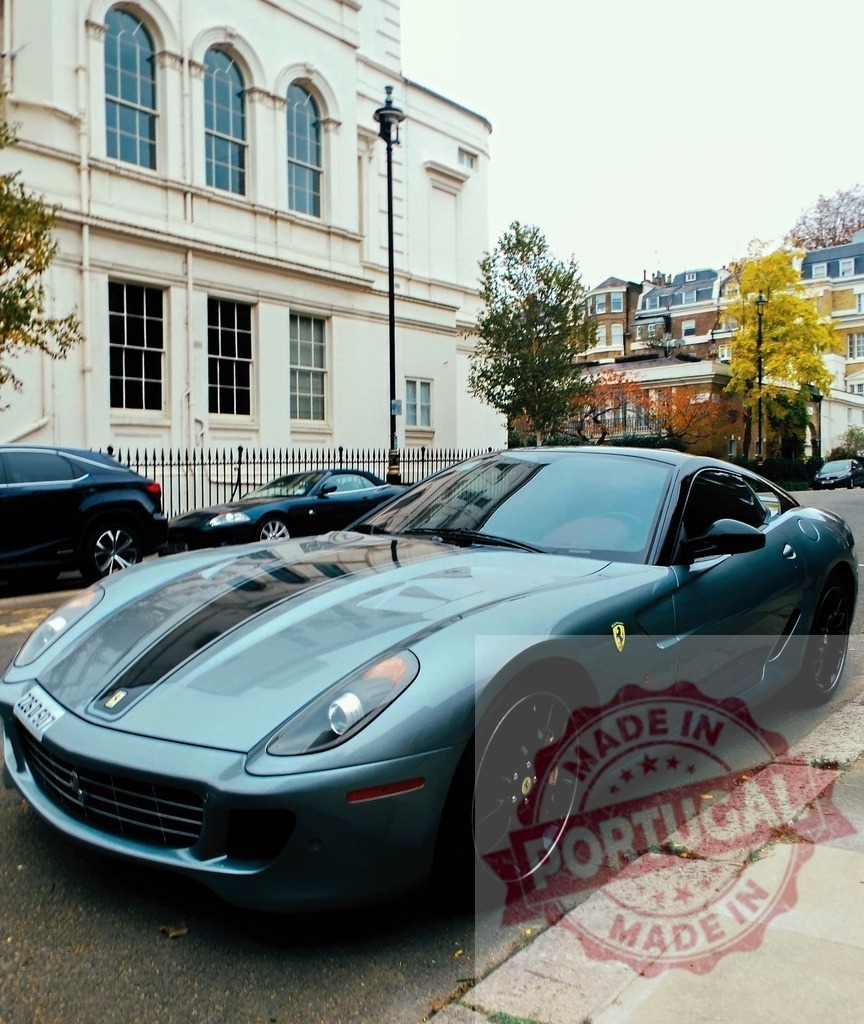 Gray Ferrari 599 GTB Fiorano parking in London near a white building | Stylish gray sport Ferrari 599 GTB Fiorano with black racing stripes parked on a London street near a white building - Realisiert mit Pictrs.com