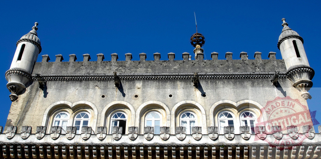 Pena Palace historical architecture with crenellations and turrets against blue sky | Pena Palace detail view showing part of the façade with windows, crenellations, and turrets - Realisiert mit Pictrs.com