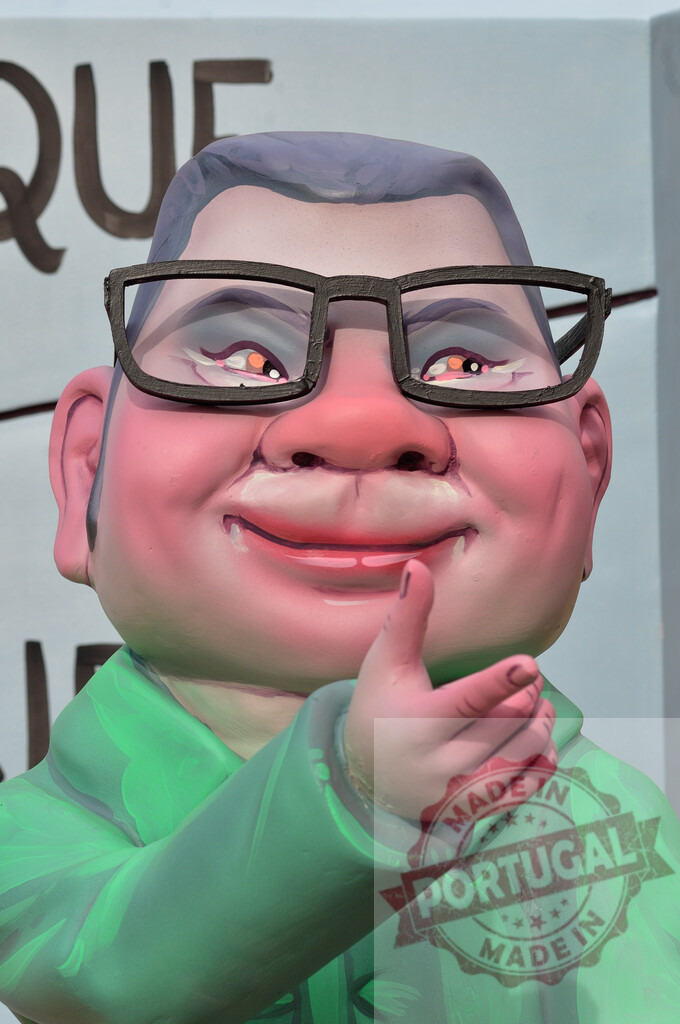 Colorful caricature sculpture celebrating Fallas festival in Valencia. Fallas Fiestas Communidad Valenciana | Colorful caricature sculpture with glasses and a friendly gesture shown at Fallas - Realized with Pictrs.com