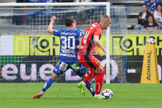 TSV Egger Glas Hartberg vs SK Rapid Wien – Championship Group    | Hartberg, Austria, 19.Apr.26 - SOCCER - ADMIRAL Bundesliga, TSV Egger Glas Hartberg vs SK Rapid Wien. The image shows Lukas Fridrikas (Hartberg) and Nenad Cvetkovic (SK Rapid Wien). 