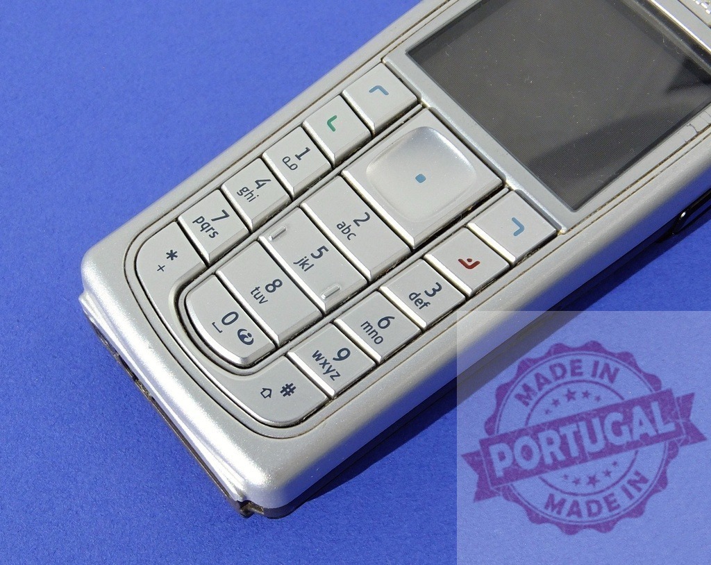 Nokia mobile phone showing keypad on blue background | Old Nokia cell phone lying on a blue surface, highlighting the numeric keypad - Realized with Pictrs.com
