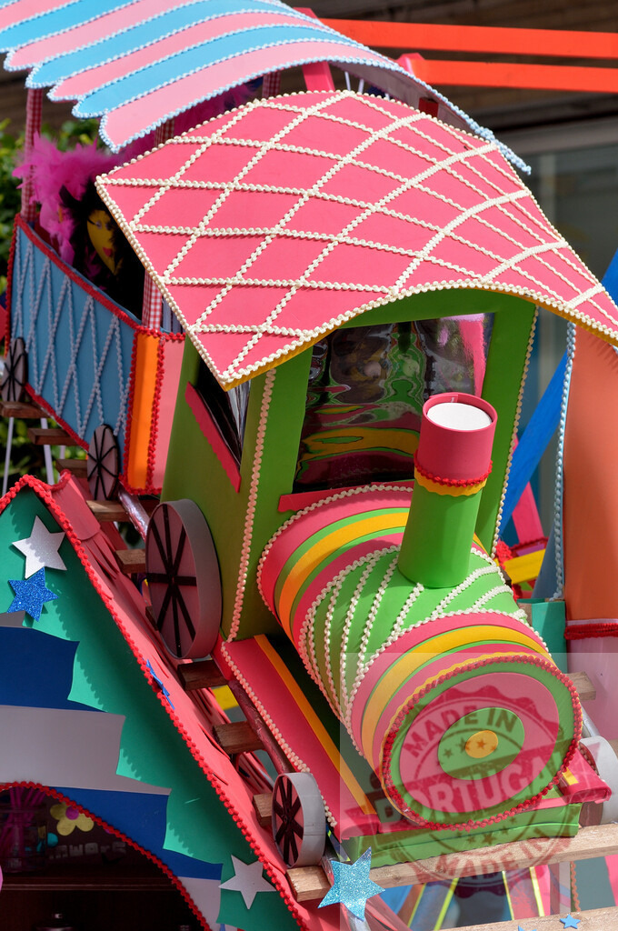 Colorful handcrafted toy train decorated for celebration. Fallas Fiestas Communidad Valenciana | Handcrafted toy train featuring bright colors, geometric patterns, and festive decorations - Realized with Pictrs.com