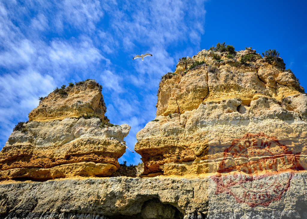 Limestone cliffs and rock formations with seagull flying in blue sky | Seagull flying over natural limestone rock formations along the ocean coast with blue sky - Realized with Pictrs.com