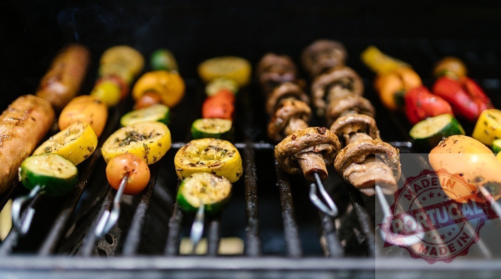 Grilling skewers with mushrooms, vegetables, and sausage | Skewers with mushrooms, vegetables, and sausage cooking on an outdoor grill with smoke - Realized with Pictrs.com