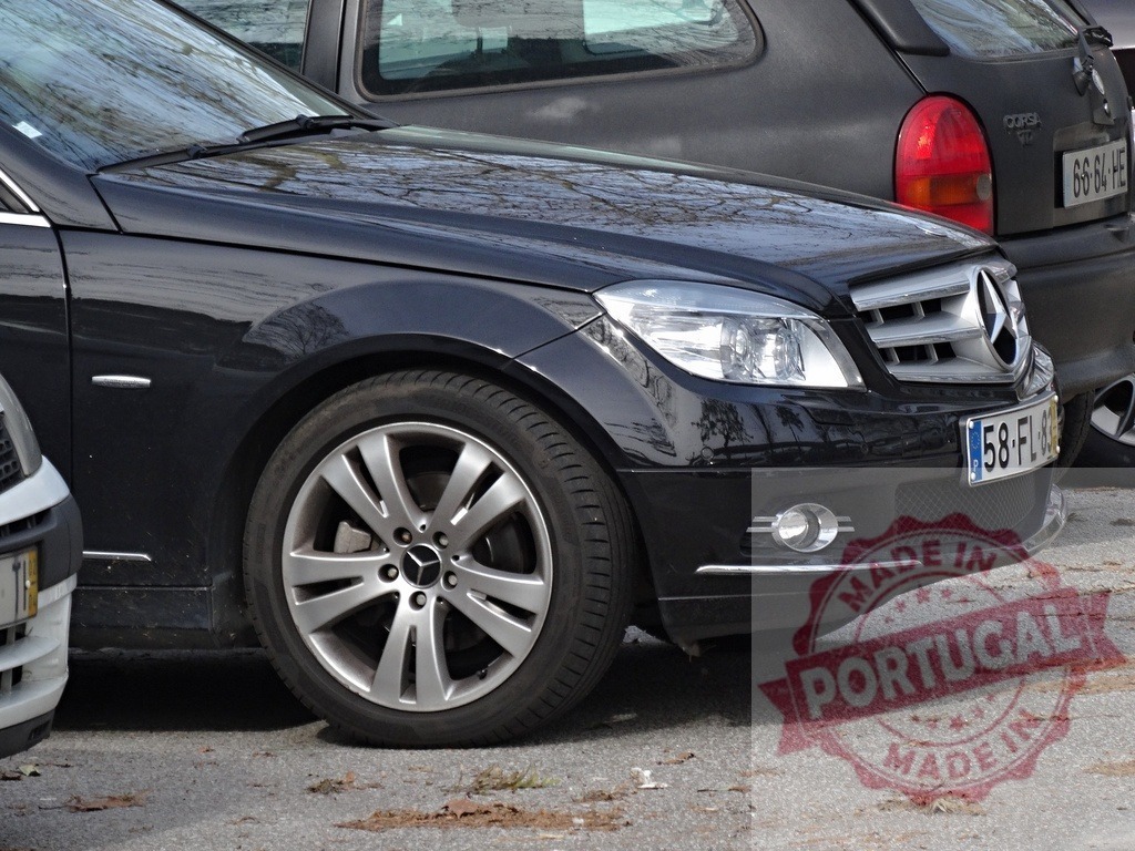 Black Mercedes-Benz C-Class sedan parked outdoors | Black Mercedes-Benz C-Class sedan parked on asphalt showing front fender and wheel - Realized with Pictrs.com