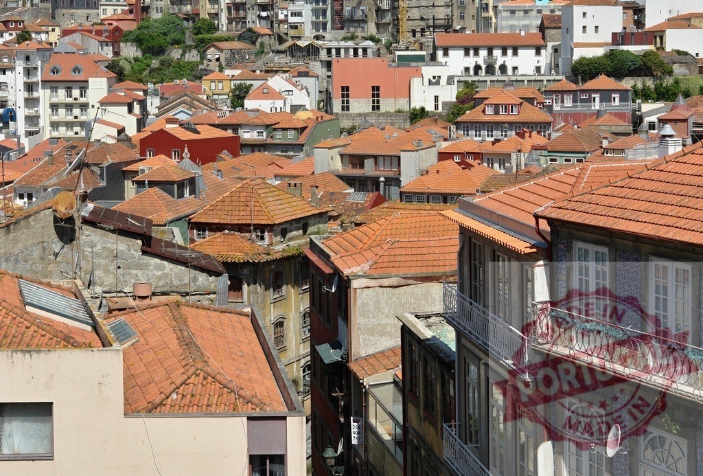 Porto Ribeira district rooftops with urban density | Colorful terracotta tiled rooftops creating a dense urban landscape in the historic city of Porto - Realized with Pictrs.com