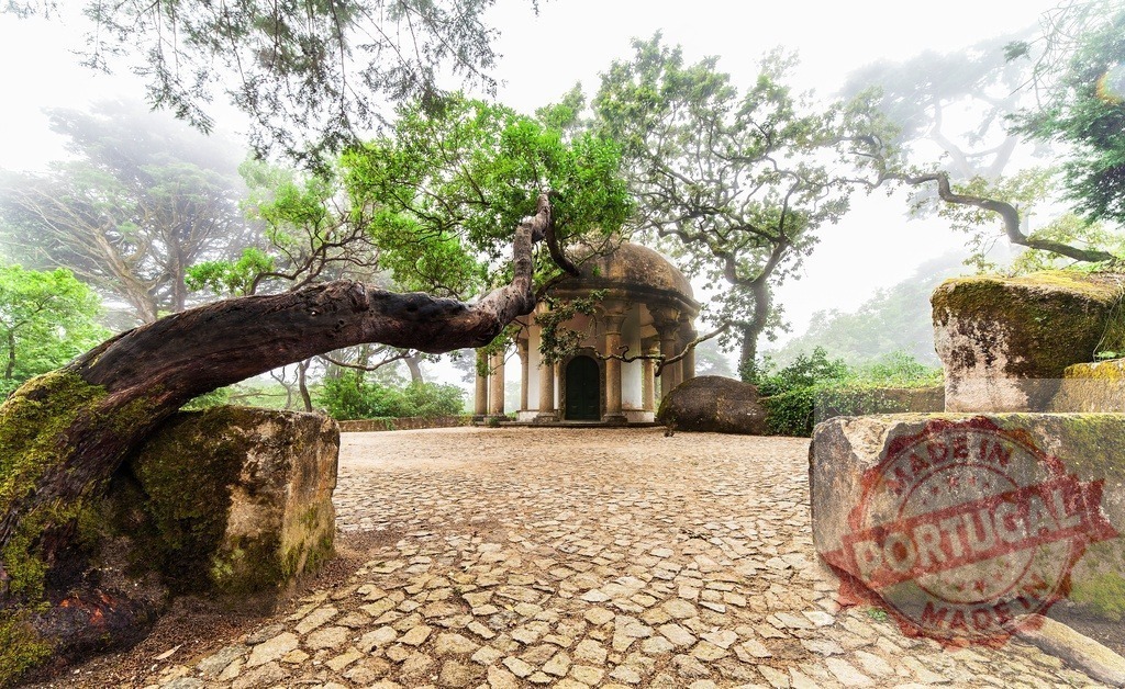 Monserrate Palace ancient temple and garden in foggy Sintra | Monserrate Palace garden temple, a grotto-like structure, with an old tree in a foggy atmosphere - Realized with Pictrs.com