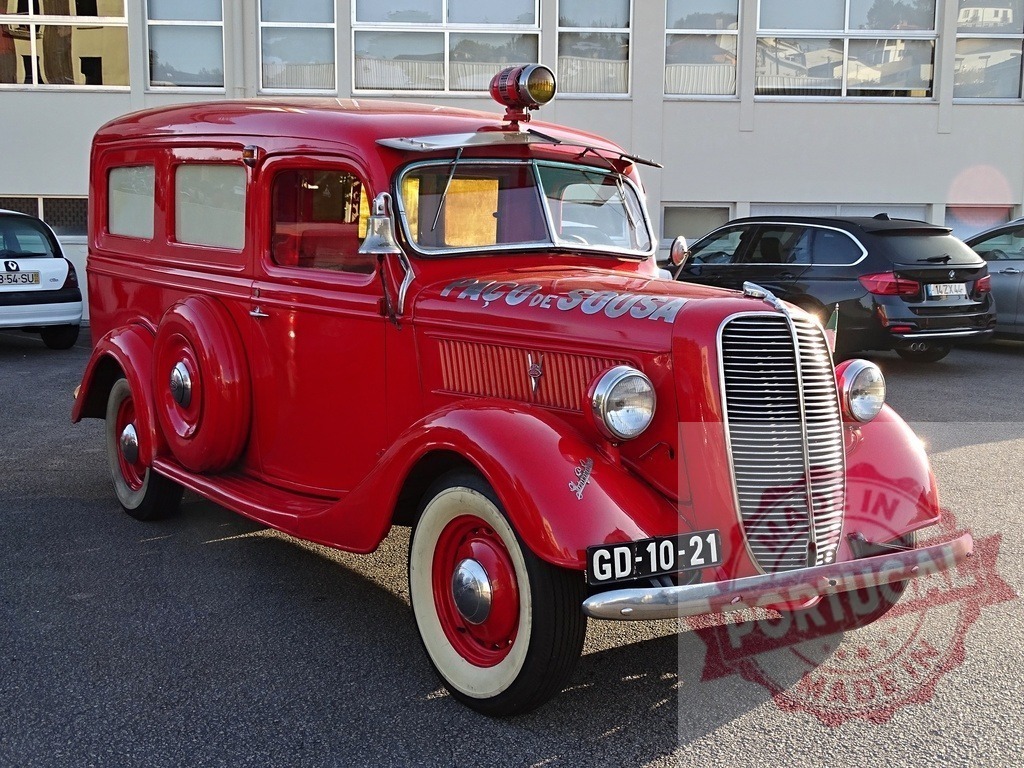 Vintage red Paço de Sousa fire truck parked | Classic red fire truck from Paço de Sousa, Portugal, showing vintage design and emergency history - Realized with Pictrs.com