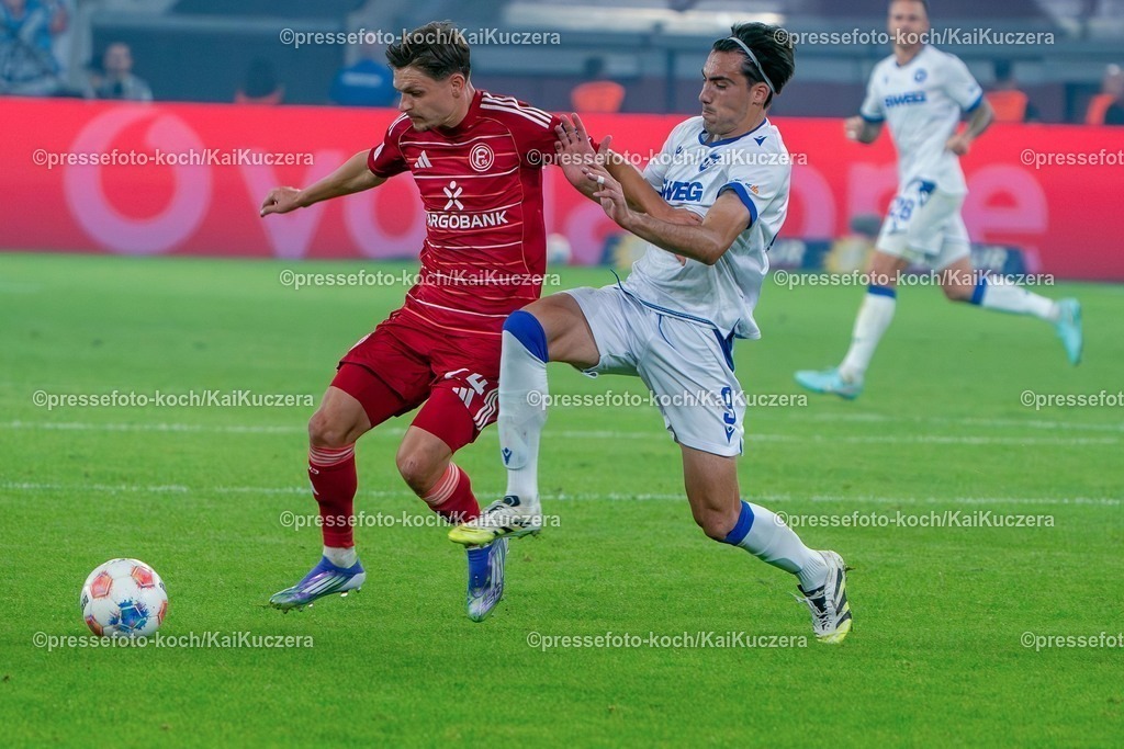 xKKUx30082501028 | 30.08.2025, xkkux, Fußball, Fortuna Düsseldorf - Karlsruher SC, 2. Fußball Bundesliga, Merkur Spiel-Arena, Saison 2025 2026: Florent Muslija&nbsp;(Fortuna Düsseldorf #24) im Zweikampf gegen  Roko Simic&nbsp;(KSC #09)  DFB regulations prohibit any use of photographs as image sequences and or quasi-video.