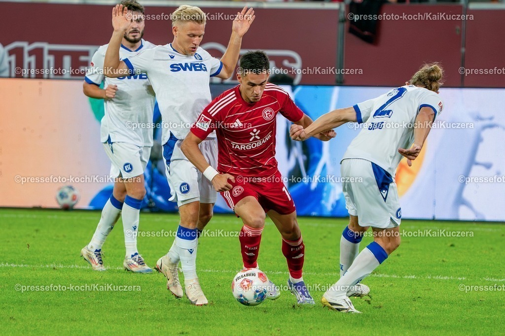xKKUx30082501039 | 30.08.2025, xkkux, Fußball, Fortuna Düsseldorf - Karlsruher SC, 2. Fußball Bundesliga, Merkur Spiel-Arena, Saison 2025 2026: Sotiris Alexandropoulos&nbsp;(Fortuna Düsseldorf #14) im Zweikampf gegen  Sebastian Jung&nbsp;(KSC #02)  DFB regulations prohibit any use of photographs as image sequences and or quasi-video.