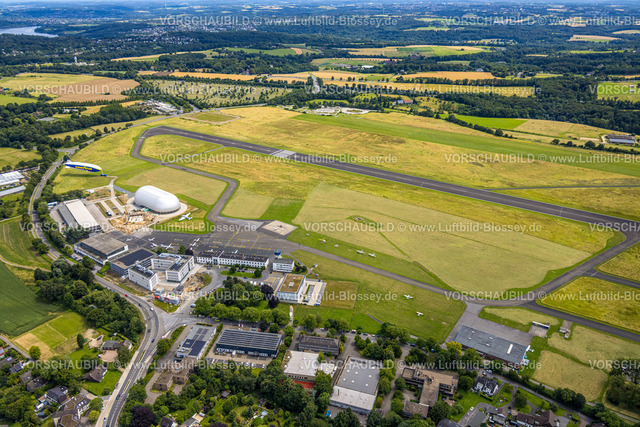 Essen240702597 | Luftbild, Flughafen Essen/Mülheim, Baustelle neben der Luftschiffhalle und Zeppelin Goodyear, Startbahn und Landebahn, geparkte Flugzeuge, Baustelle und Neubau Bürohäuser mit Parkhaus am Beykozplatz, Lilienthalstraße, Fernsicht, Haarzopf, Essen, Ruhrgebiet, Nordrhein-Westfalen, Deutschland