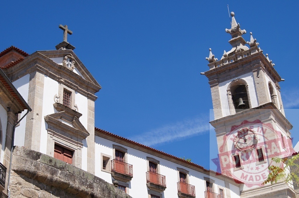 Viseu Cathedral bell tower and church facade | Viseu Cathedral showing its historic architecture against a clear blue sky - Realisiert mit Pictrs.com