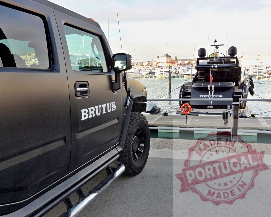 Black hummer and yacht brutus parked at the dock | Luxury black hummer and yacht Brutus parked at the dock in a marina - Realized with Pictrs.com