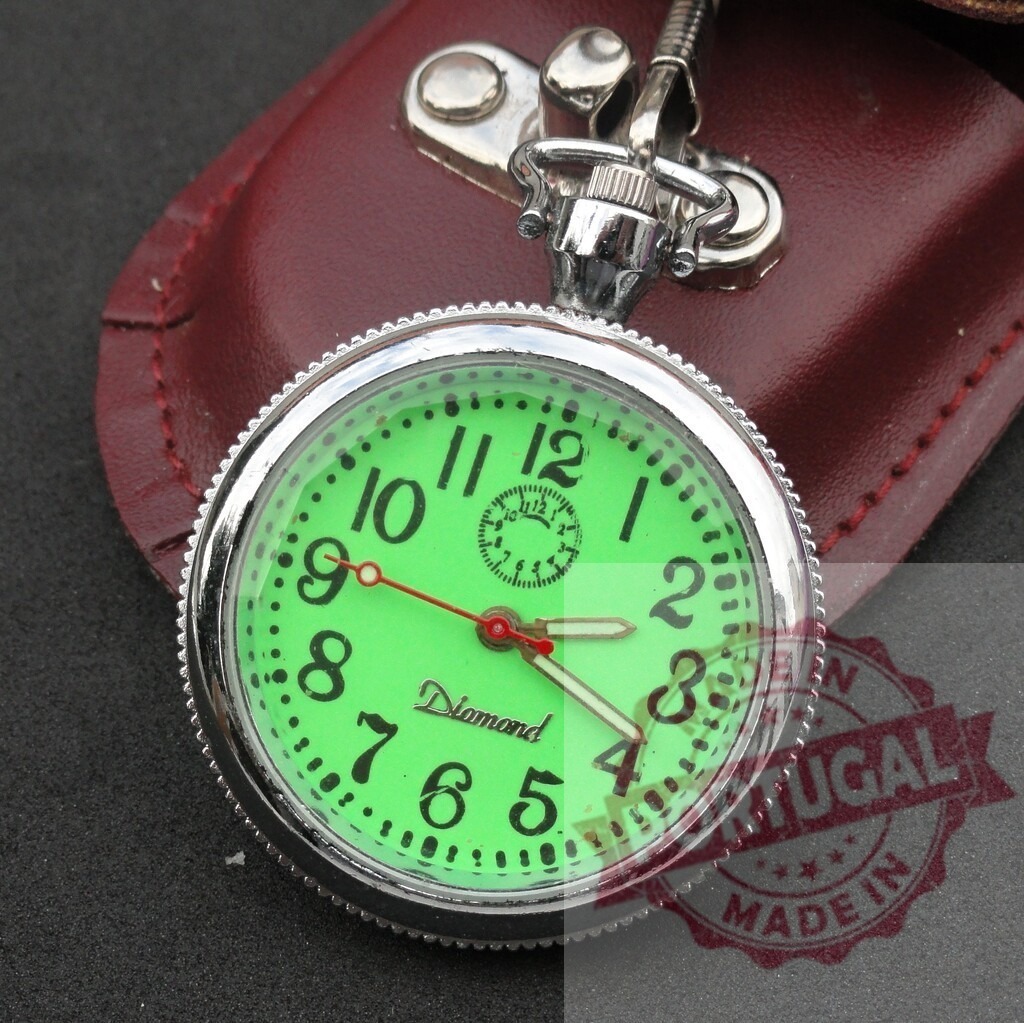 Vintage Diamond pocket watch showing green glowing dial | Vintage Diamond pocket watch resting on its leather case, displaying a green glowing dial - Realisiert mit Pictrs.com