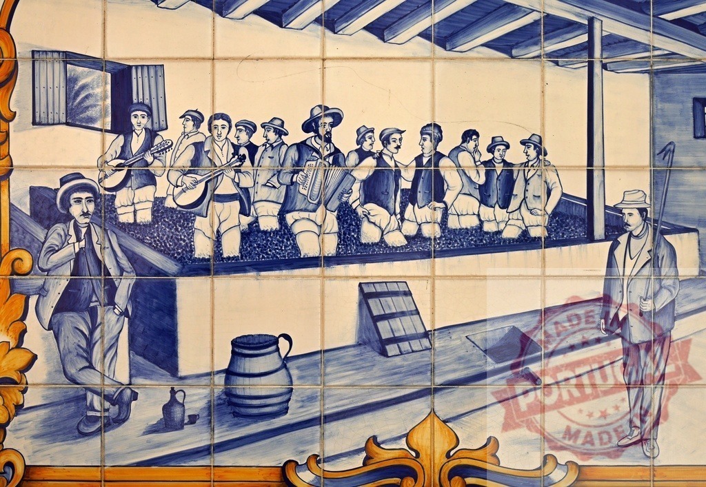 Azulejo mural depicting traditional Portuguese grape stomping | Portuguese Azulejo mural portraying historical grape treading for winemaking during harvest - Realized with Pictrs.com