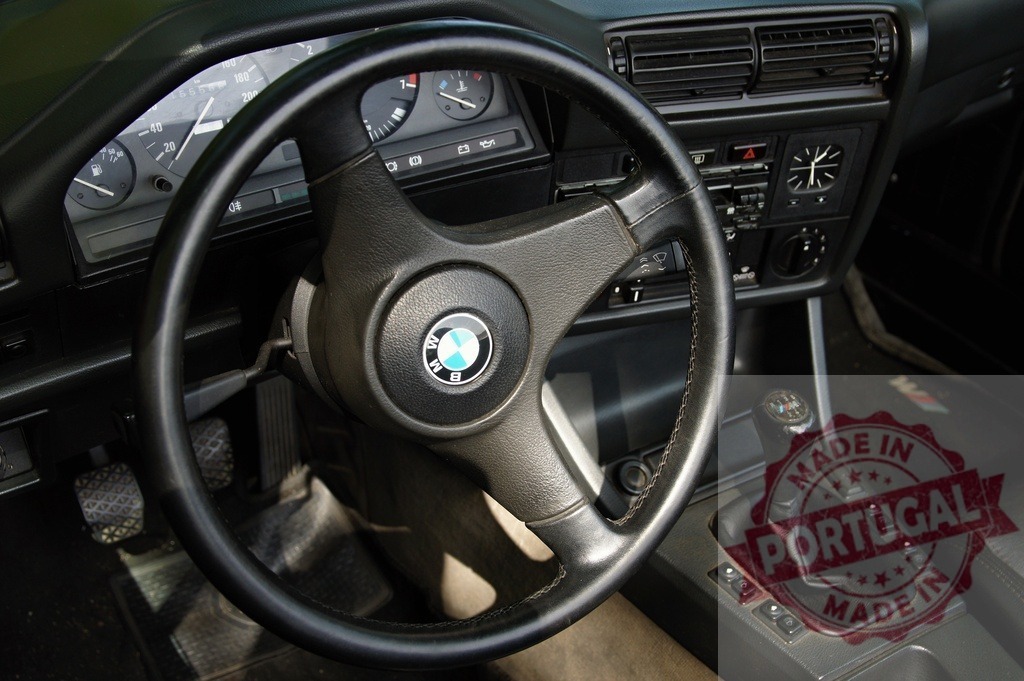 BMW E30 M3 interior with dashboard and steering wheel | BMW E30 M3 car interior featuring the dashboard, steering wheel, and manual shifter - Realized with Pictrs.com