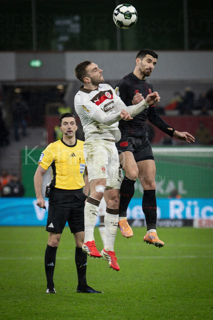 Bayer 04 Leverkusen vs. FC St. Pauli, 03.02.2026 | LEVERKUSEN, GERMANY - FEBRUARY 3:  Referee Florian Badstuebner (Nuernberg) looks at a tackle between James Sands (FC St. Pauli, 6) and Martin Terrier (Bayer 04 Leverkusen, 11) during the DFB Cup quarter-final match Bayer 04 Leverkusen vs. FC St. Pauli at BayArena on February 3, 2026 in Leverkusen, Germany. (Photo by Axel Kohring/Beautiful Sports Int.)DFL REGULATIONS PROHIBIT ANY USE OF PHOTOGRAPHS AS IMAGE SEQUENCES AND/OR QUASI-VIDEO.