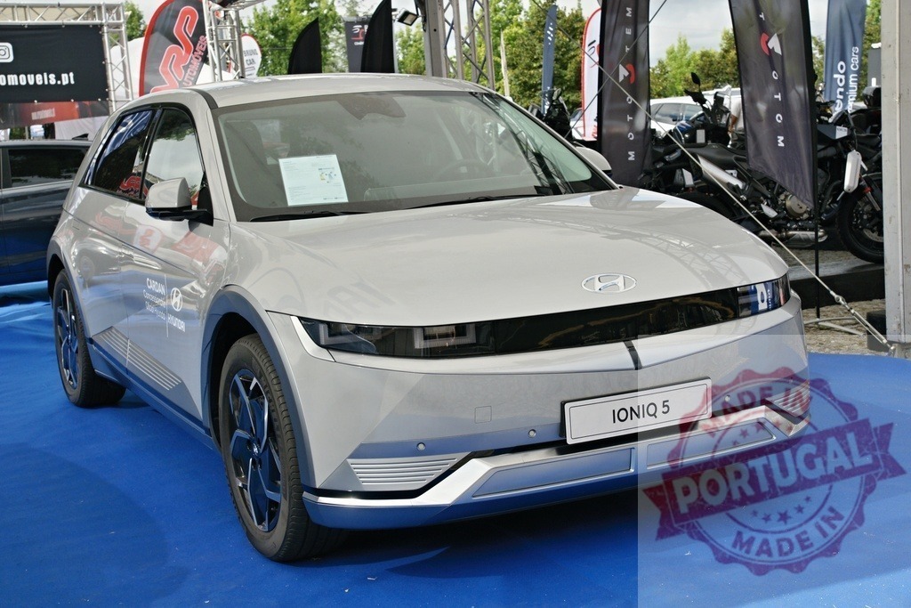 Hyundai Ioniq 5 electric SUV on display at car show | Hyundai Ioniq 5 electric vehicle presenting its modern design at an outdoor auto exhibition event - Realized with Pictrs.com