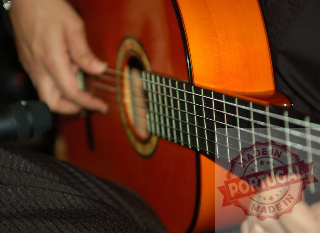 Musician playing classical guitar during a musical performance | Hands of a musician strumming strings on a classical acoustic guitar during a performance - Realized with Pictrs.com