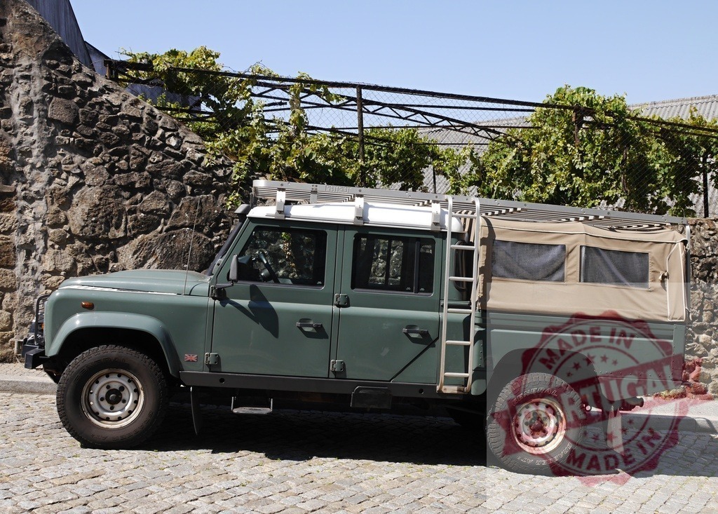 Land Rover Defender 4x4 expedition truck on cobblestone street | Land Rover Defender 4x4 expedition truck parked on a cobblestone road, ready for adventure - Realisiert mit Pictrs.com