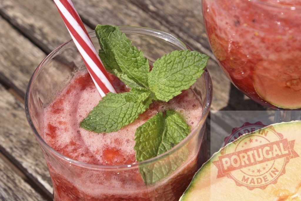 Melon mint smoothie refreshing summer drink | Melon mint smoothie with a straw on a wooden table, perfect for summer - Realized with Pictrs.com