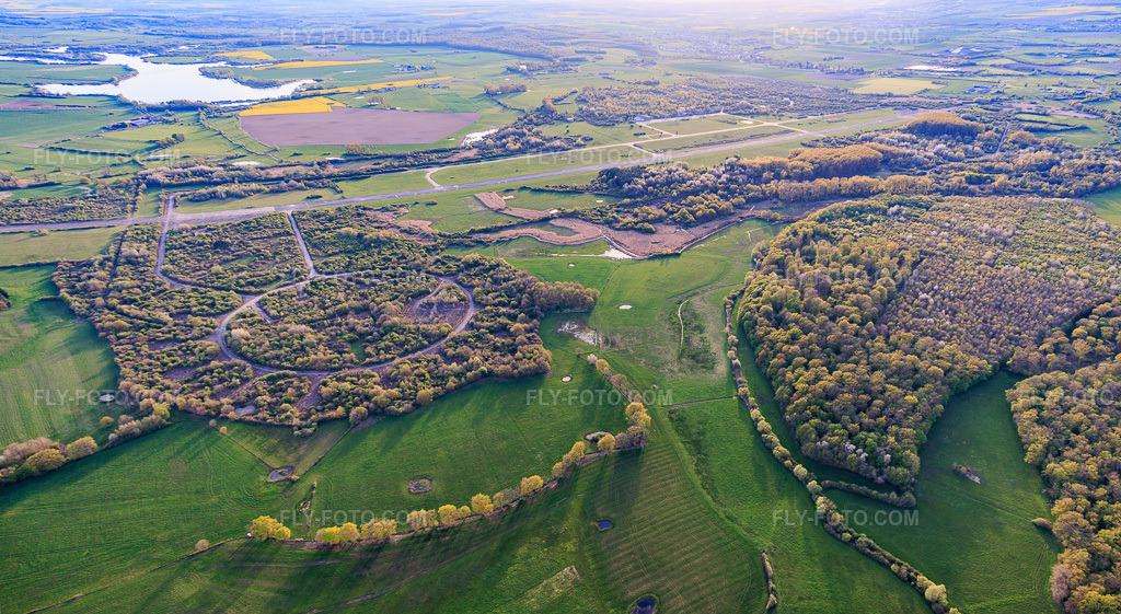 Aerial view: Former military airfield Grostenquin from the northeast in Grostenquin in the state Moselle, France. – Photo: IMG_154741-Pano.jpg taken on 04/17/2026 by Werner Riehm/FLY-FOTO.com – Resolution of the original: 7770 x 4259 px