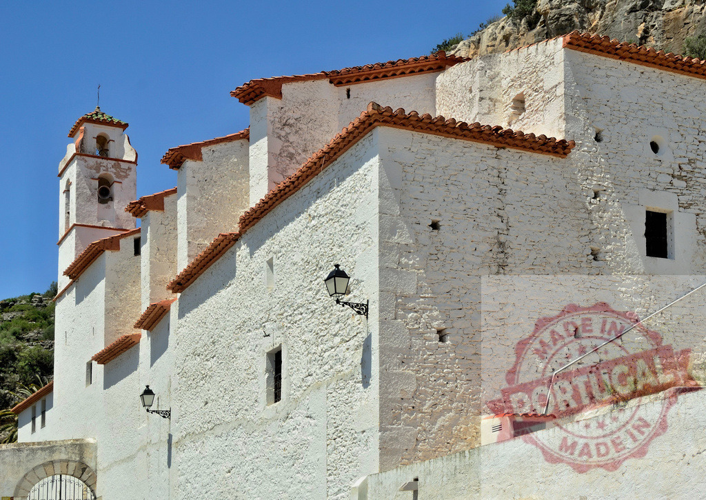 White historic church building with bell tower in Spain. Spain - Castellon | White stucco architecture of a traditional church against a blue sky, reflecting Mediterranean heritage - Realisiert mit Pictrs.com