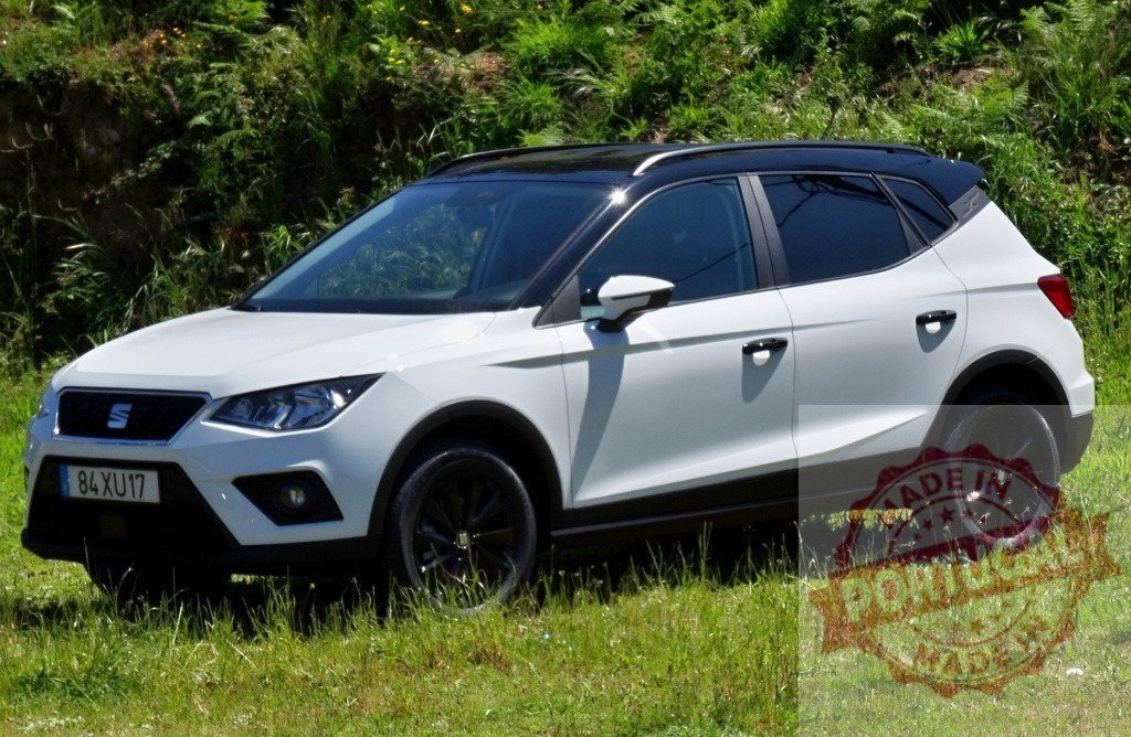 White Seat Arona crossover SUV parked on grass | Seat Arona compact SUV parked outdoors on green grass under sunlight - Realized with Pictrs.com